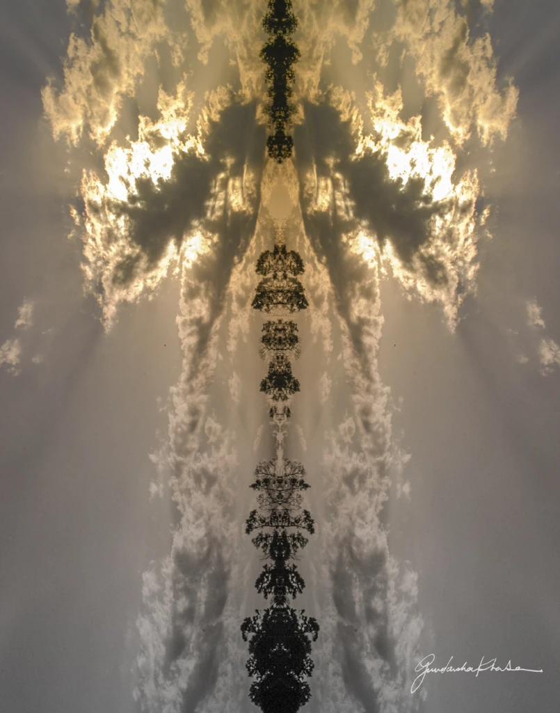 Angelic Whisper, a mirrored image of sunlit clouds with a column of tree silhouettes rising through the centre